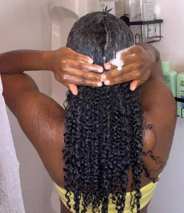 woman applying shampoo and conditioner