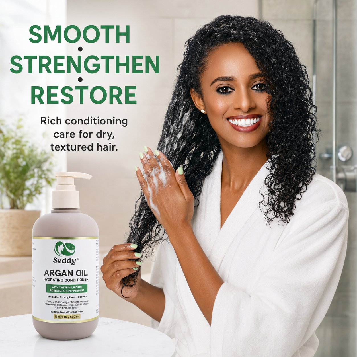 A smiling woman with long, glossy, curly hair wearing a white robe holds up a lathered hair conditioner while standing next to a bottle of Neddy Argan Oil Hydrating Conditioner. The background is a bright, modern bathroom with a shower visible, and the text 'SMOOTH STRENGTHEN RESTORE' is displayed on the left.