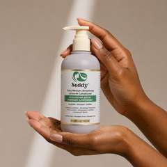 a woman holding the leave in conditioner on her hands