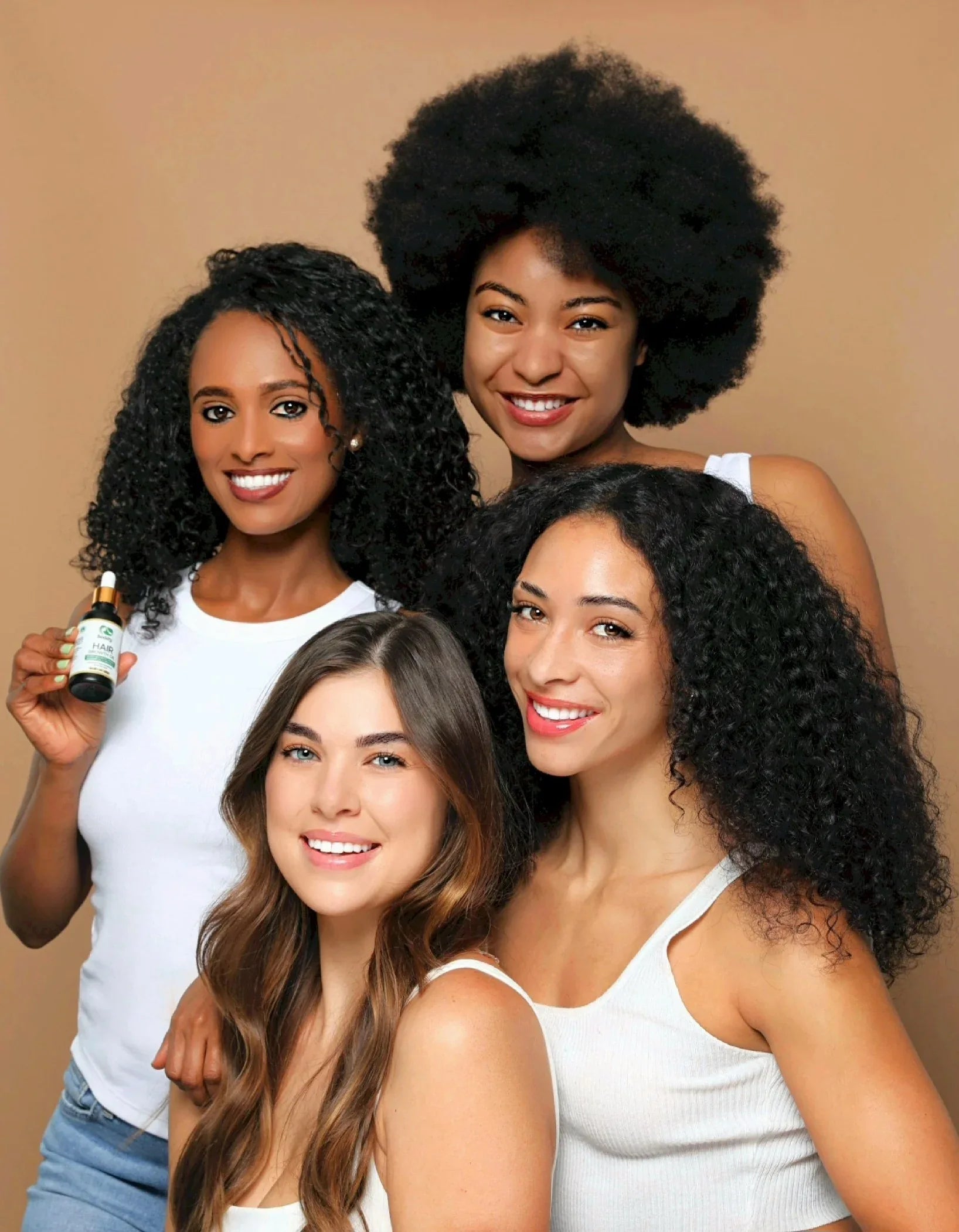 Seddy holding hair growth oil with models